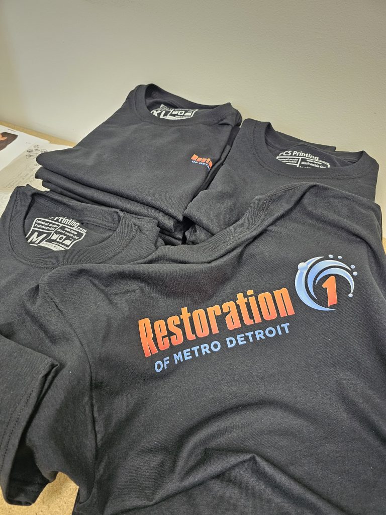 Folded custom printed shirts by Fan Club Shirts