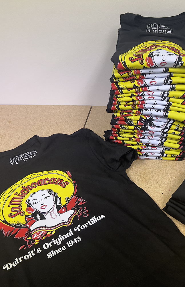 A stack of freshly printed Fan Club Shirts tees